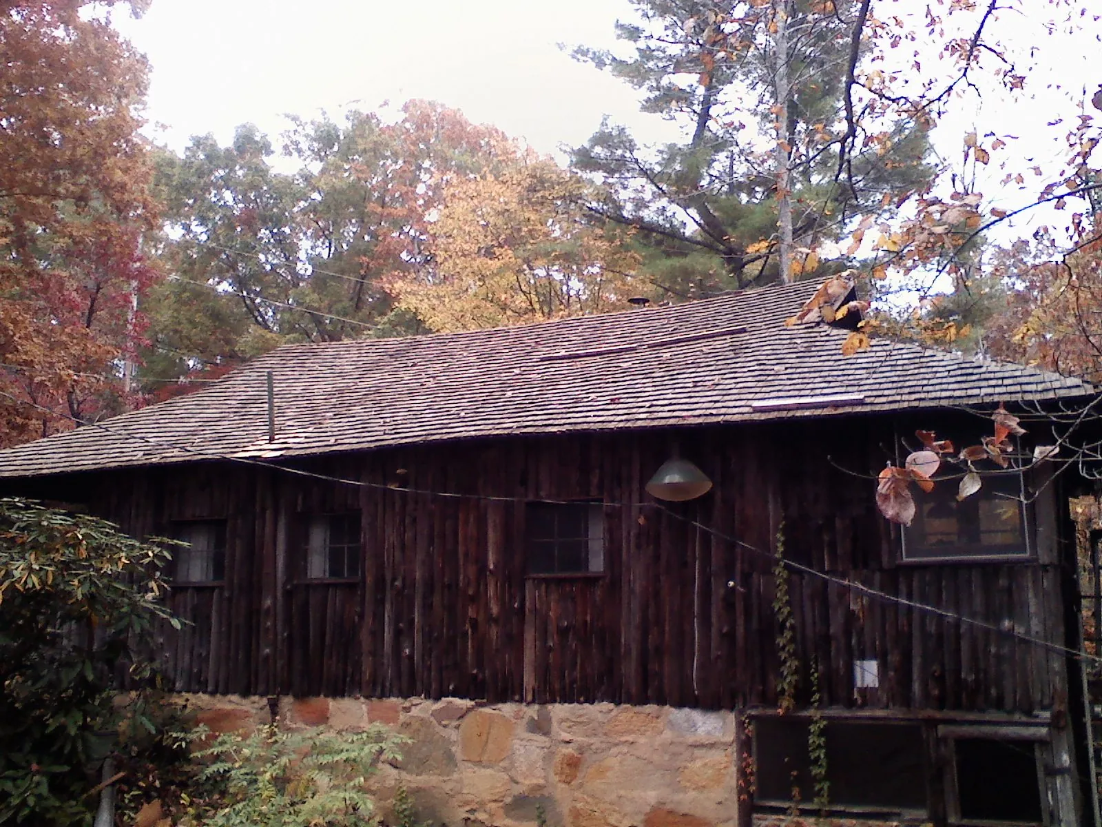 Weathered wood shake roof on a rustic board sided cabin in Catharpin