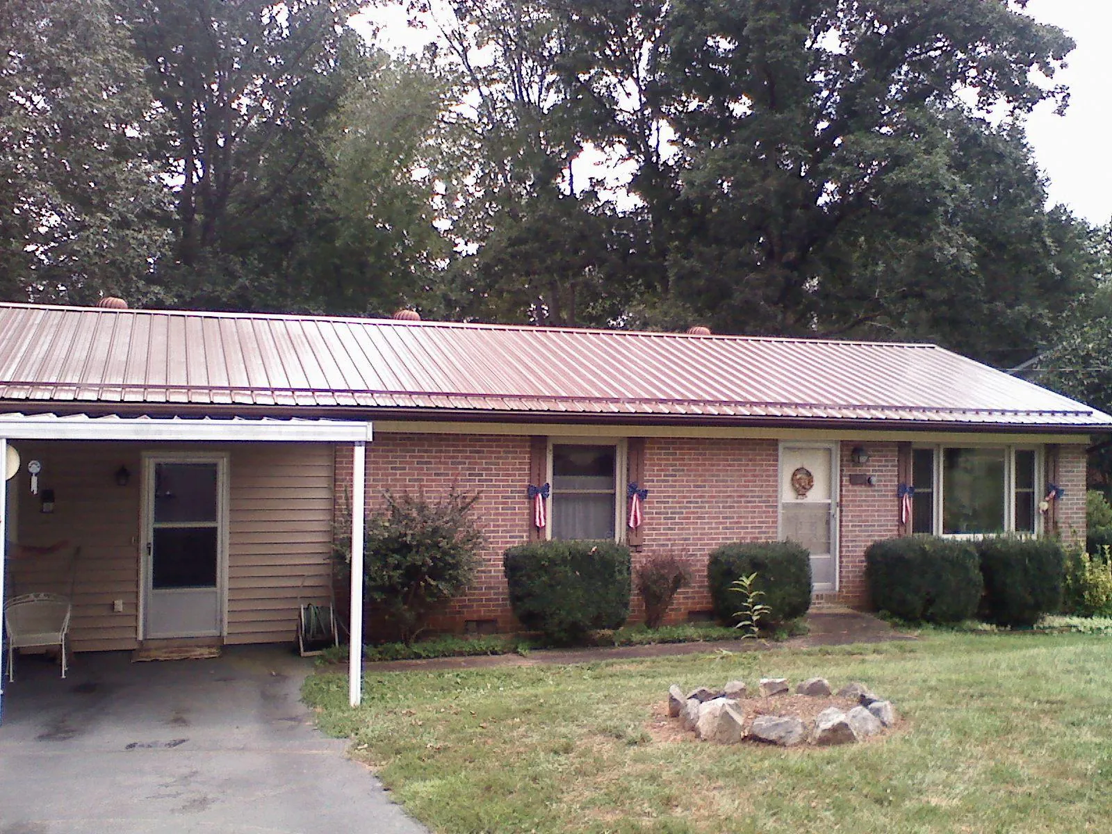 Bronze metal roof and carport on a brick ranch home — Roof Repair work by our crew in Catharpin